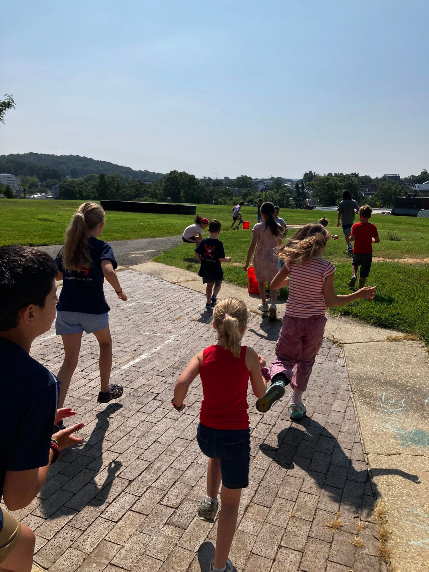 Kids running and playing outdoors at Old City Kids summer camp