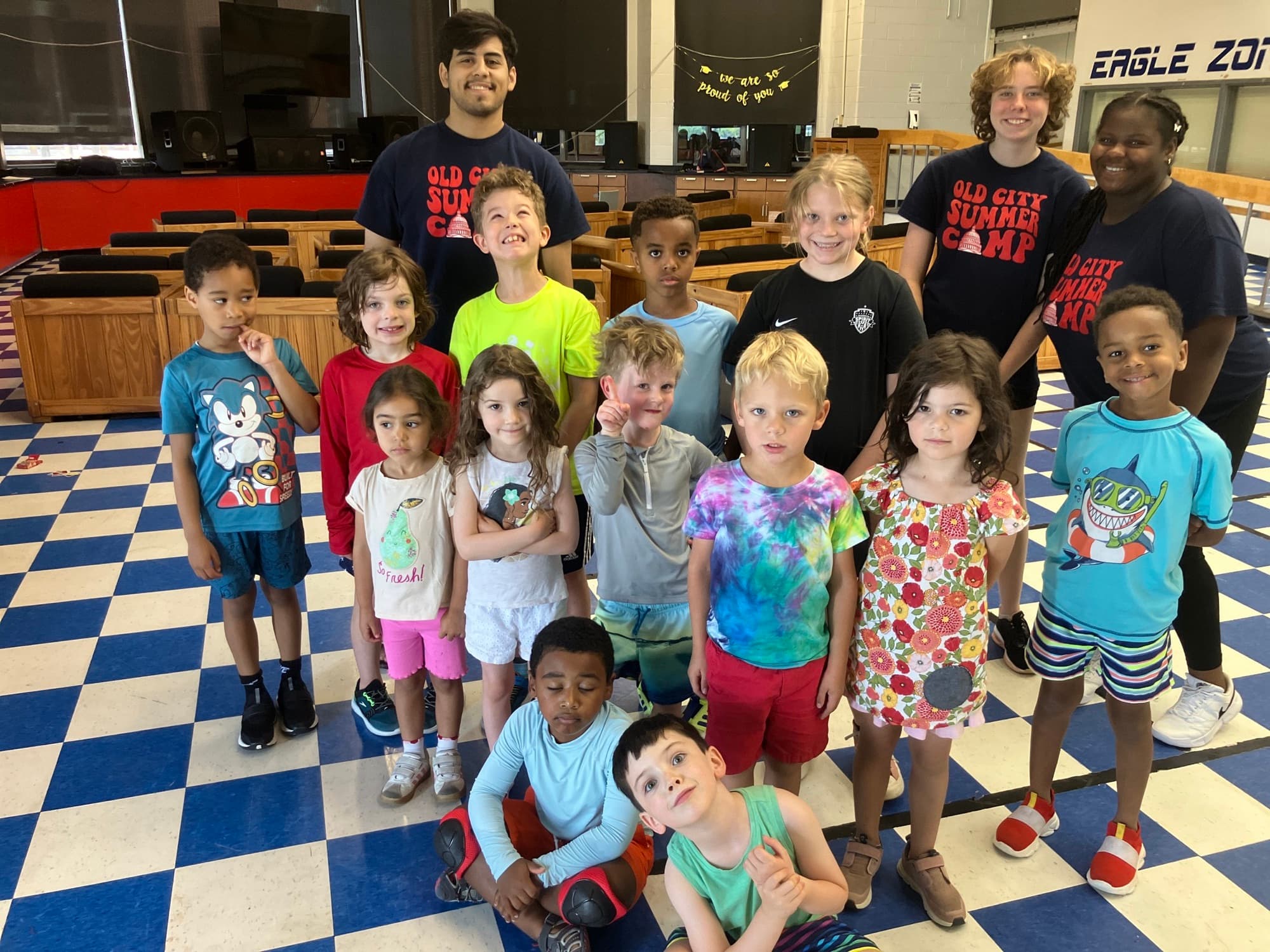 Campers and coaches posing under an Old City Summer Camp banner