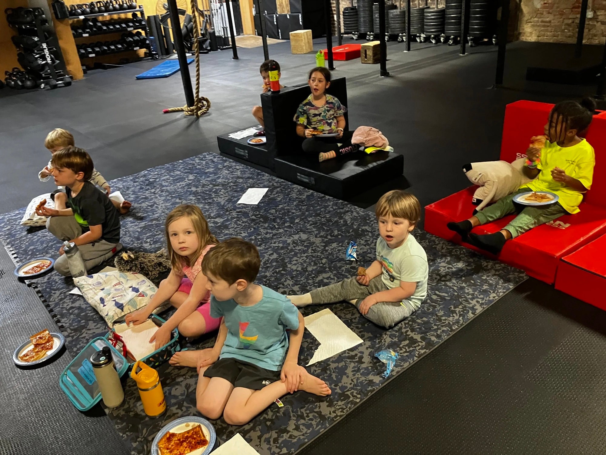 Kids sitting together in the gym watching a movie on the projector